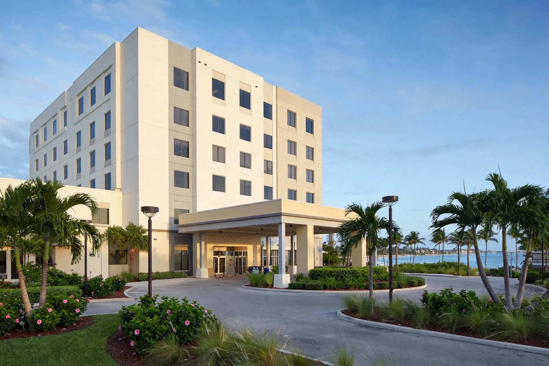 Broward Health North in Deerfield Beach, Florida — hospital building and covered entrance with palm trees